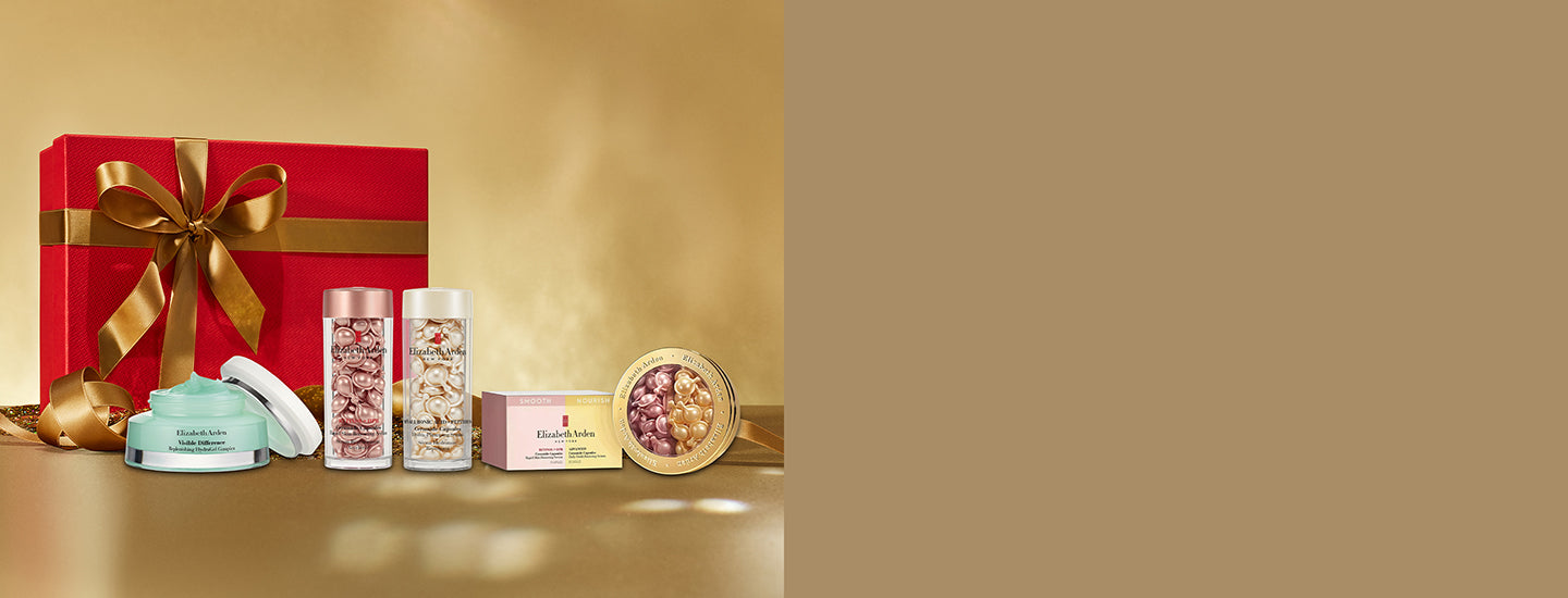 Red gift box with gold ribbon on a beige-gold background featured with Elizabeth Arden skincare products. 