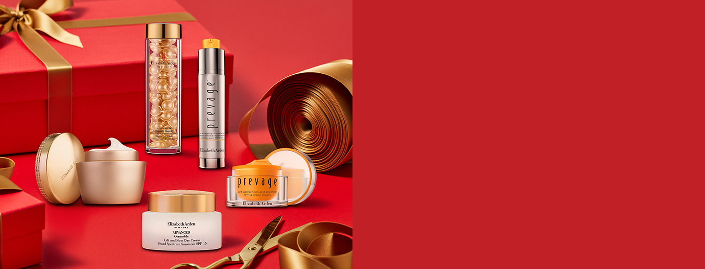 Red gift box with gold ribbon and decorative items on a red background