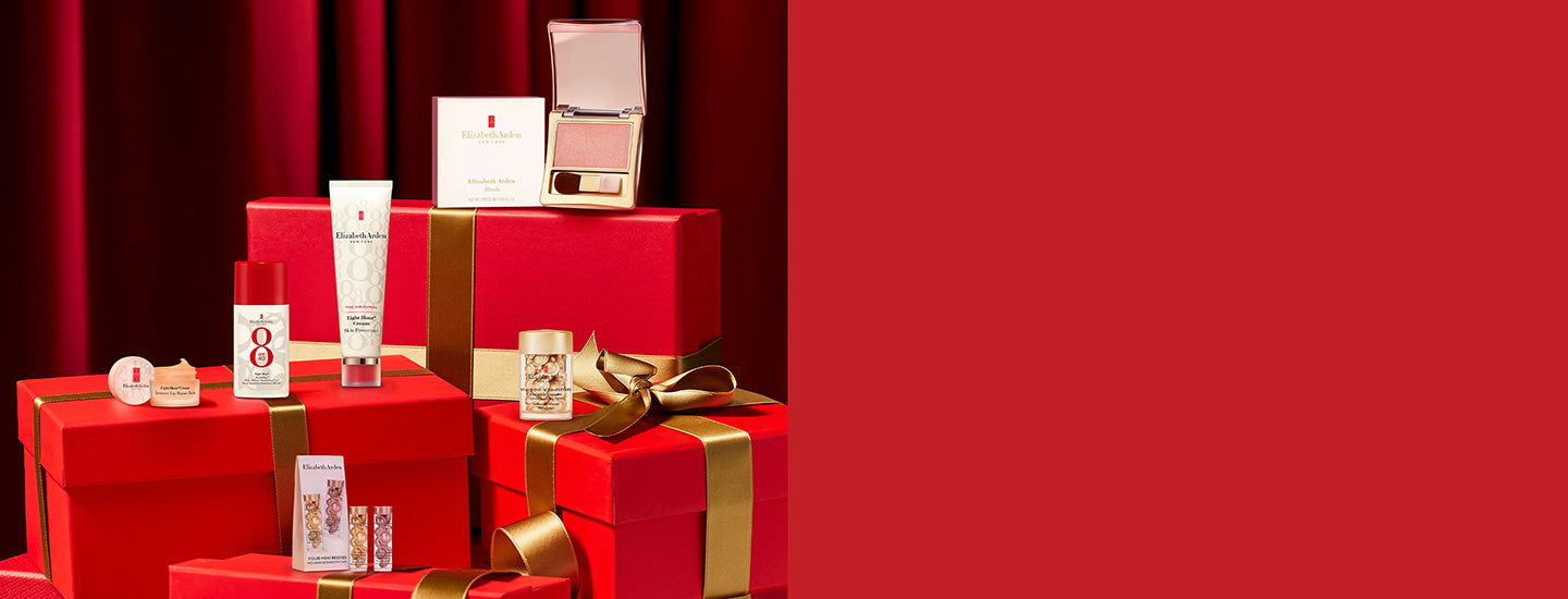 Red gift boxes and skincare products on a red background