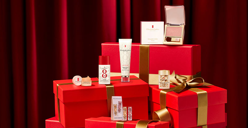 Elizabeth Arden Cosmetic products on red boxes with a red curtain background