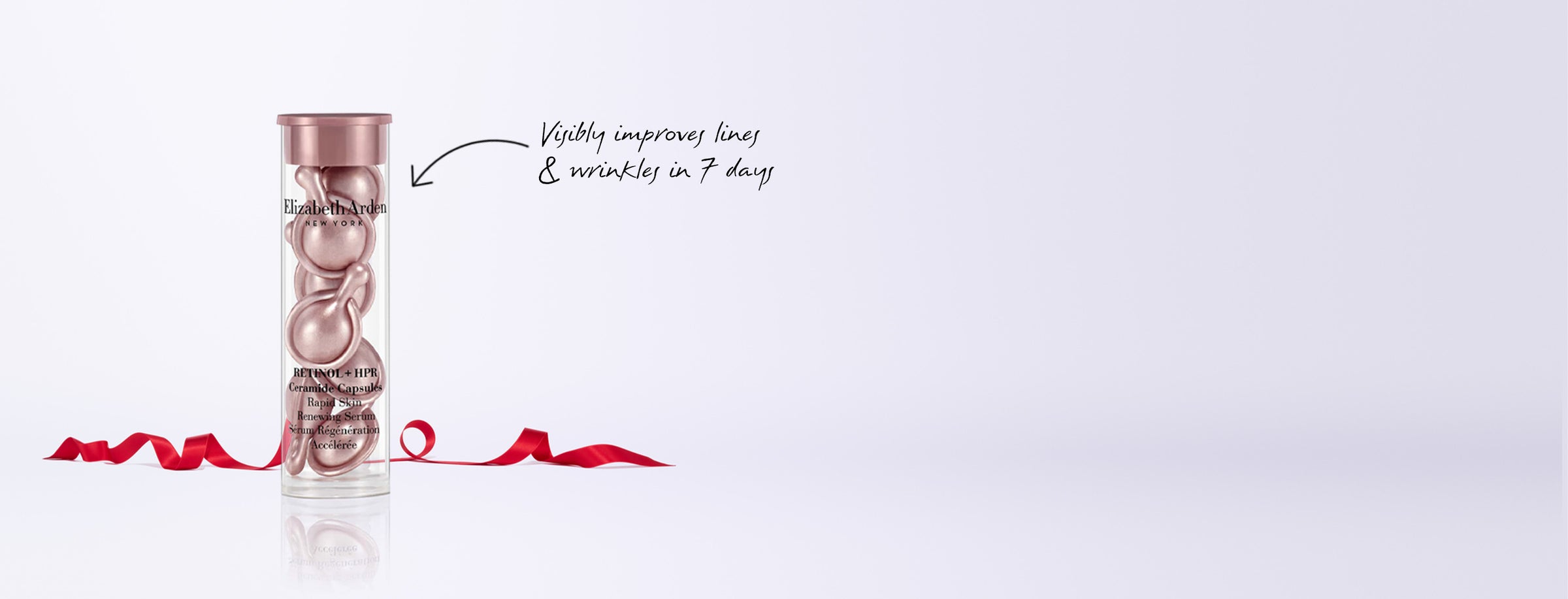 Retinol + HPR Capsules Serum which "Visibly improves lines & wrinkles in 7 days" with a red ribbon on a white background