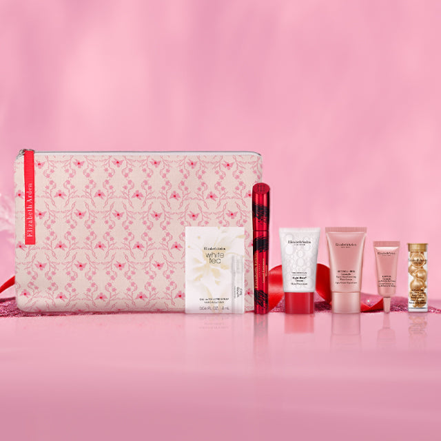 Set of skincare products and a pouch on a pink background