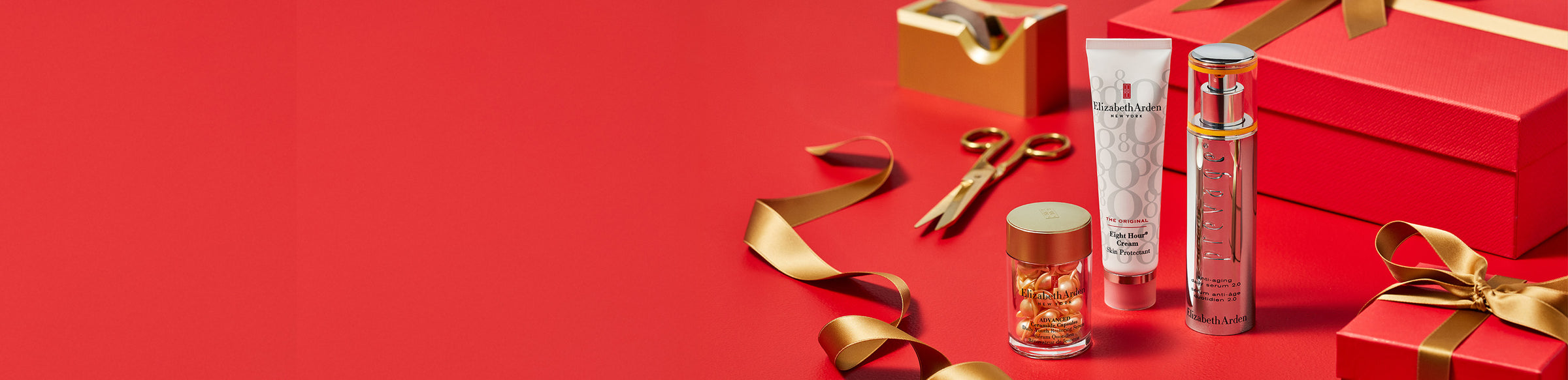 Elizabeth Arden skincare products featured with red gift boxes with gold ribbons and red accents on a red surface