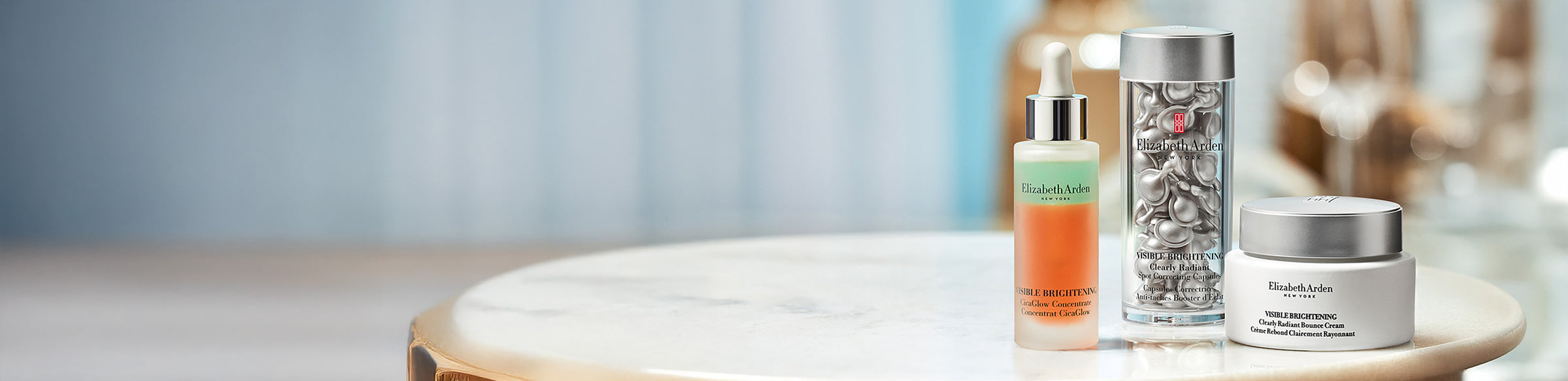 Elizabeth Arden Skin care products on a marble top table featured on a blue background