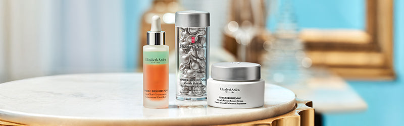 Elizabeth Arden Skin care products on a marble top table featured on a blue background