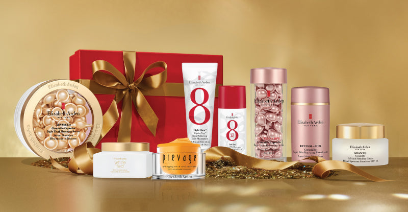 Set of skincare products with a red gift box on a gold background