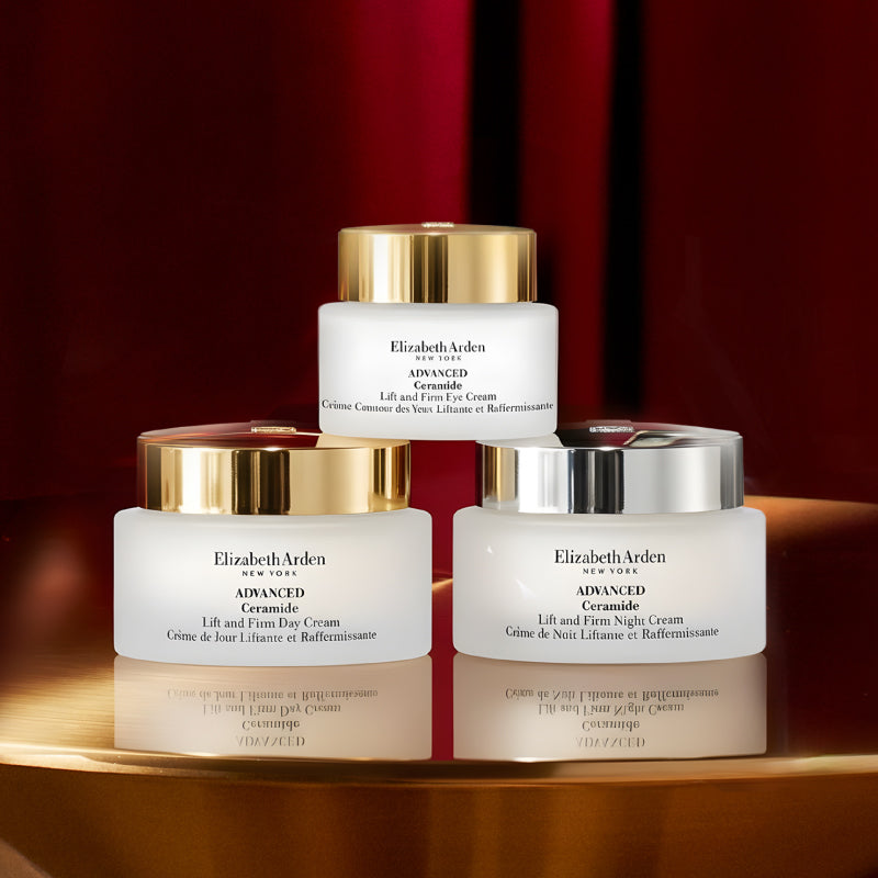 Three jars of Elizabeth Arden cream on a reflective surface with a red background