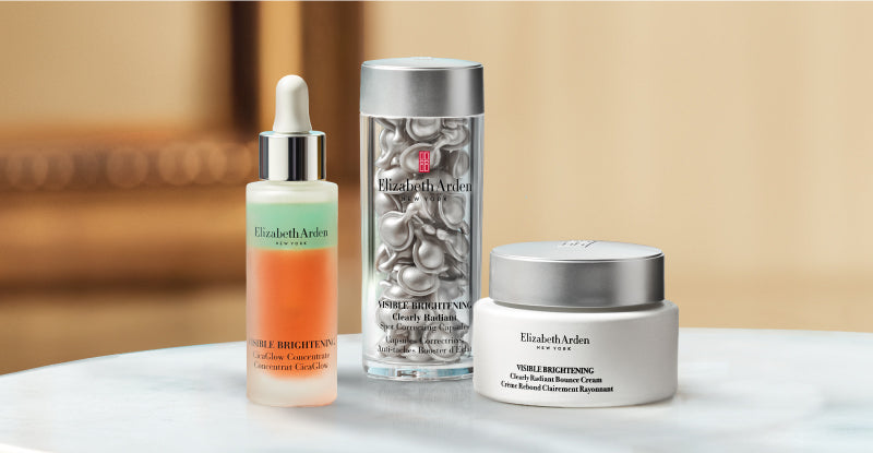 Collection of Elizabeth Arden Visible Brightening skincare products on a blurred beige background