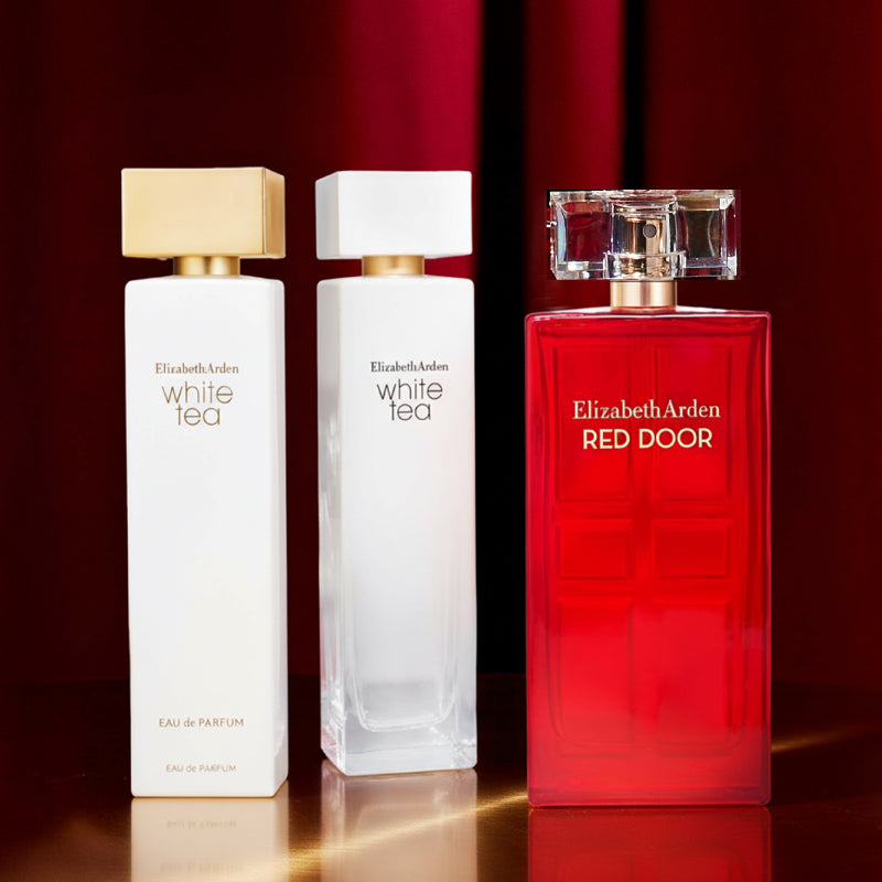 Three Elizabeth Arden perfume bottles on a reflective surface with a red background