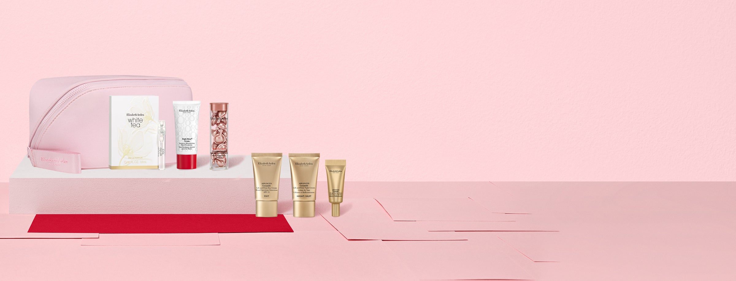 Cosmetic set with skincare products on a pink background