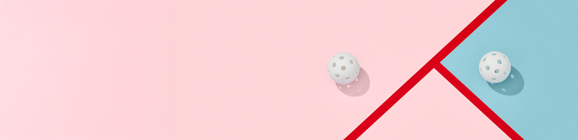 Two white balls on a pink, blue, and red geometric patterned background