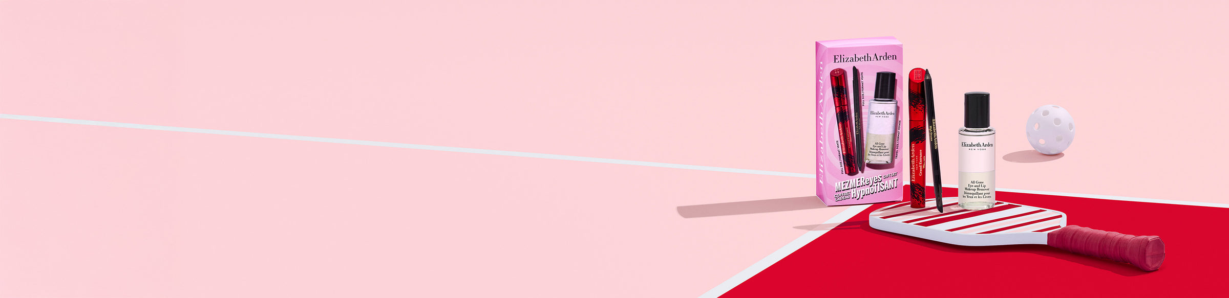 3 Elizabeth Arden makeup products on a stripe pickleball paddle on a pink and red background next to a ball and a product box.