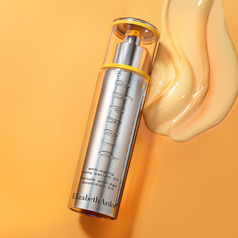 Skincare serum bottle with a droplet of product on an orange background
