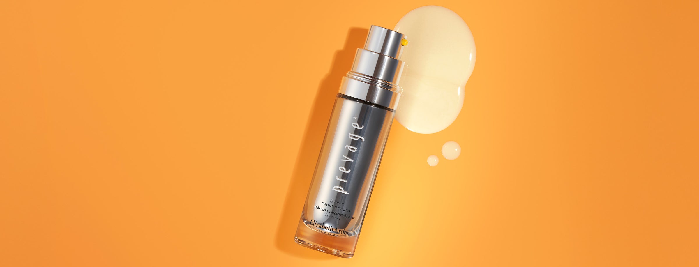 Skincare serum bottle with a droplet of product on an orange background