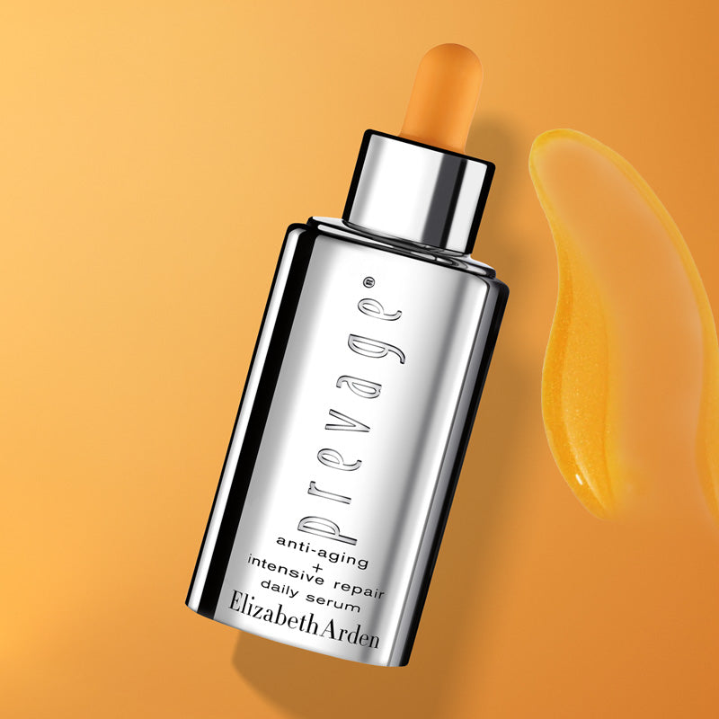 Elizabeth Arden Prevage serum bottle on an orange background with swipe of product texture