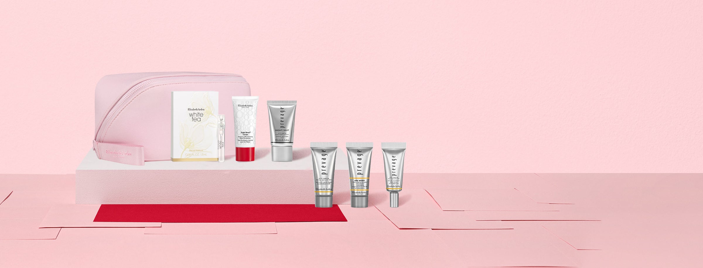Cosmetic set with skincare products on a pink background