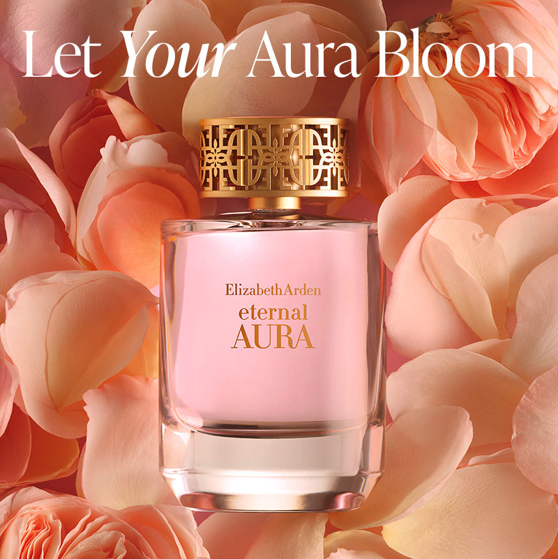 Elizabeth Arden eternal AURA perfume bottle surrounded by pink flowers with text 'Let Your Aura Bloom'.

