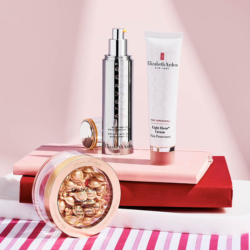 Elizabeth Arden skincare products on a pink and white striped surface
