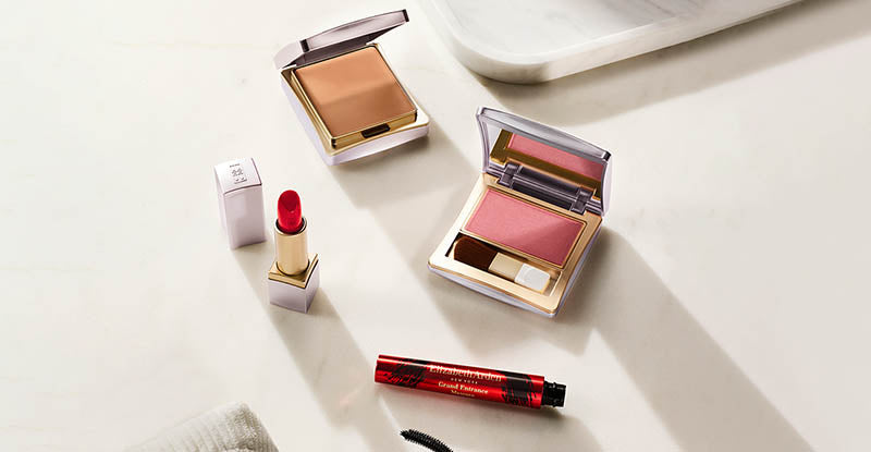 Makeup products including blushes and a lip balm on a white surface