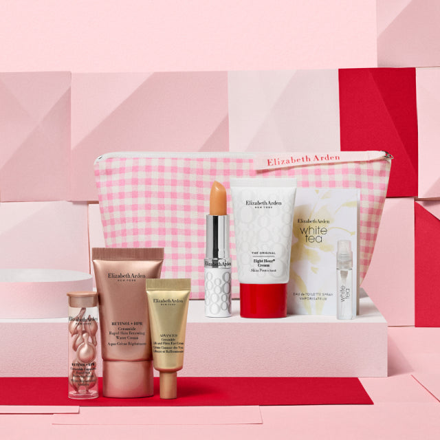 7-piece gift with purchase set of skincare products and a pink gingham cosmetic bag on a pink geometric background