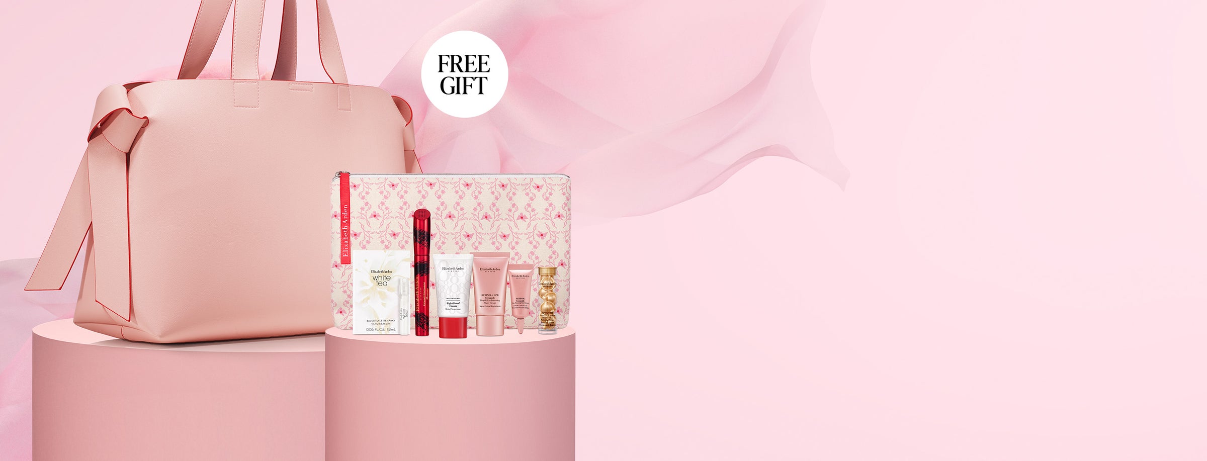 Pink tote bag with a mini skincare gift and 'FREE GIFT' label on a pink background