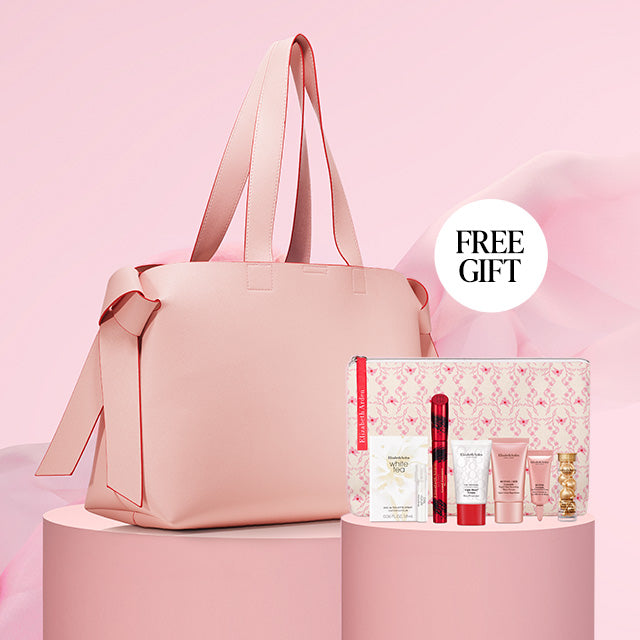 Pink tote bag with a mini skincare gift and 'FREE GIFT' label on a pink background