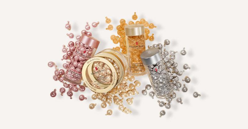 Elizabeth Arden Capsule Serums spilled on beige background