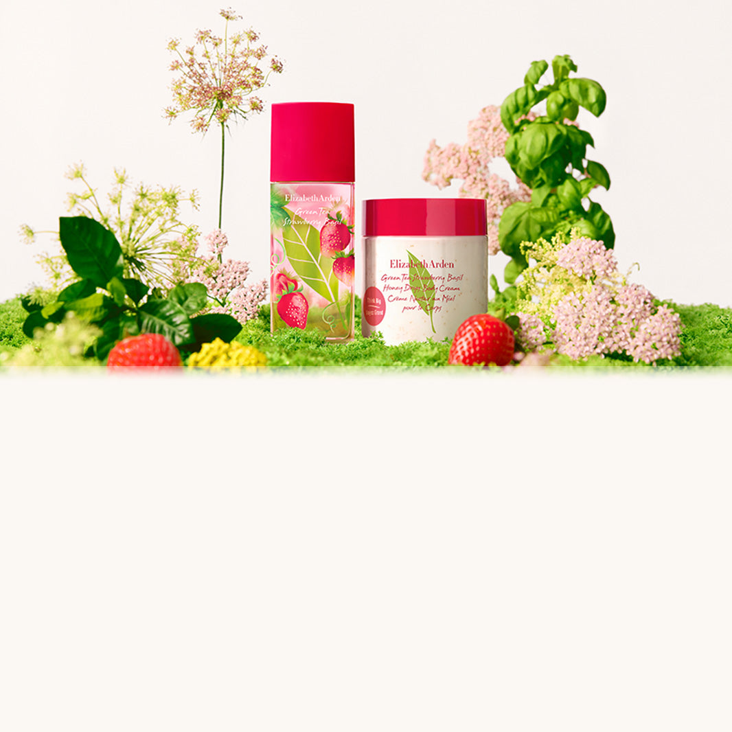 Elizabeth Arden Strawberry Basil collection products on in a bed of gren grass, plants, pink and yellow flowers and strawberries.