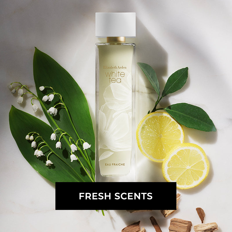 Elizabeth Arden White Tea Eau Fraiche fragrance laying among green leaves, flowers and lemons on a white-grey background. CTA reads "FRESH SCENTS"