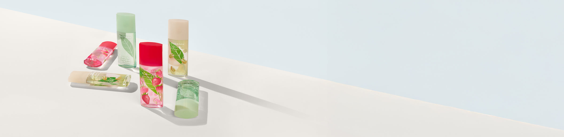 Set of fragrances from the Green Tea collection on a blue and white background