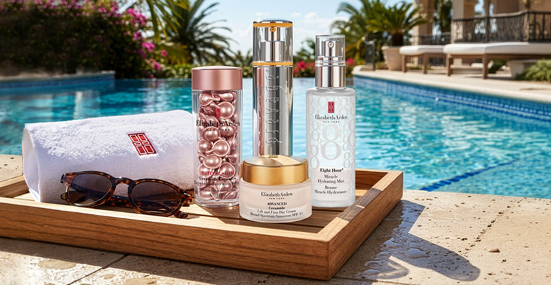 Assortment of Elizabeth Arden beauty products on a tray by a poolside with a scenic background