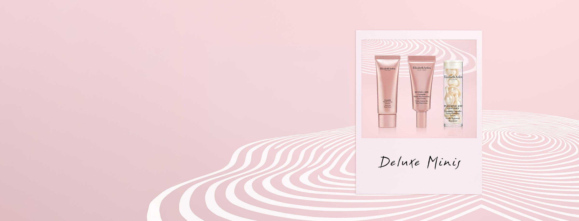 Three  Elizabeth Arden Deluxe Minis Gifts in a polaroid frame on a muted pink background with white squiggly lines and text "Deluxe Minis"