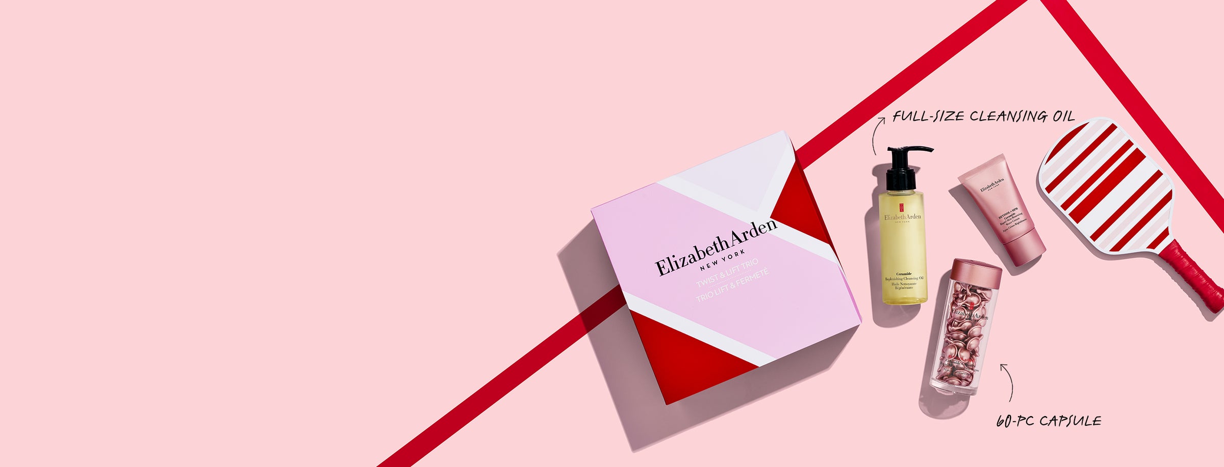 Elizabeth Arden 3-piece gift set along with gift box on pink background with red lines and paddle. Two callouts to highlight product sizes, "FULL-SIZE CLEANSING OIL" and "60-PC CAPSULE"