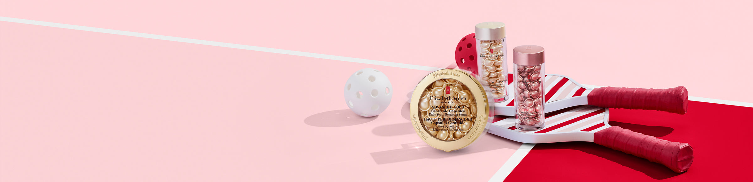 Elizabeth Arden Ceramide Capsules — Advanced Gold Ceramide Capsules Serum, Hyaluronic Acid + Peptides Ceramide Capsules Serum and Retinol + HPR Ceramide Capsules Serum on top of paddles on a pink and red background