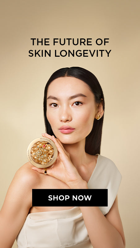 A woman holds a round gold compact containing Advanced Gold Ceramide Capsules Serum against a warm beige background, with text reading 'THE FUTURE OF SKIN LONGEVITY' and a 'SHOP NOW' button.