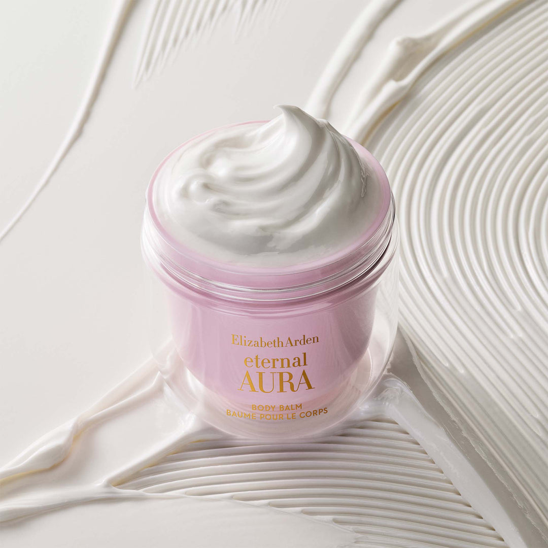 Eternal Aura Body Balm stylized with the silky texture behind it. 