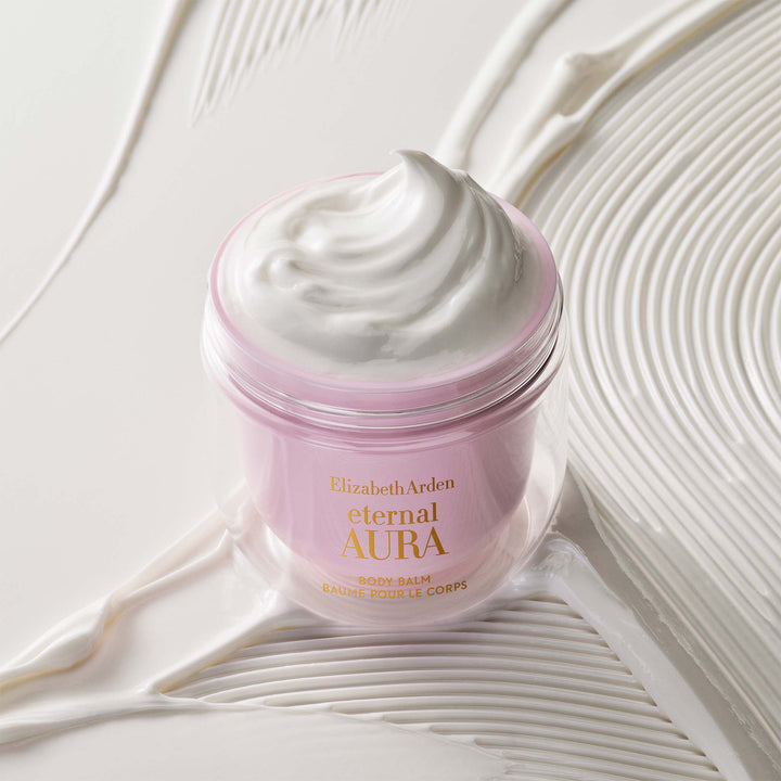 Eternal Aura Body Balm stylized with the silky texture behind it. 