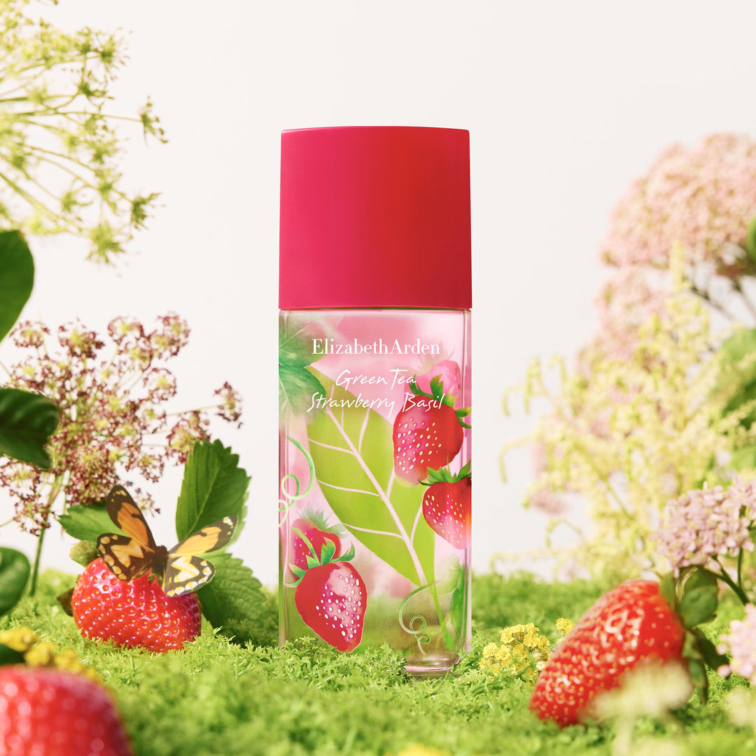 Green Tea Strawberry Basil Eau De Toilette in a garden lush cottage-core background