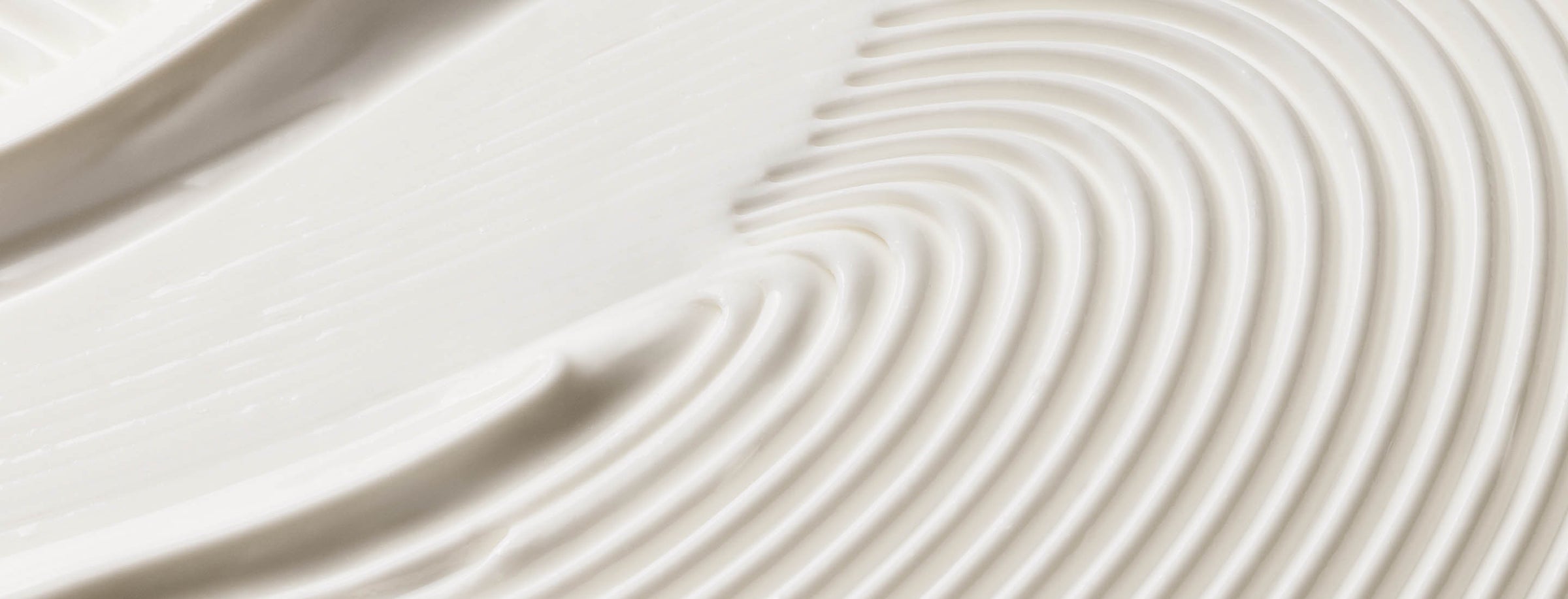 Close-up of smooth, Eternal Aura's body balm with concentric circular patterns for desktop