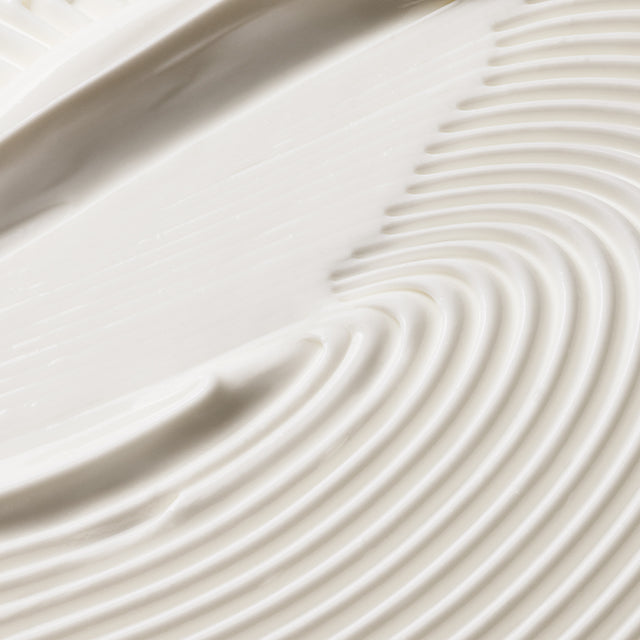 Close-up of smooth, Eternal Aura's body balm with concentric circular patterns for mobile