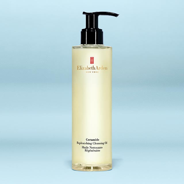 Elizabeth Arden cleansing oil bottle on a light blue background