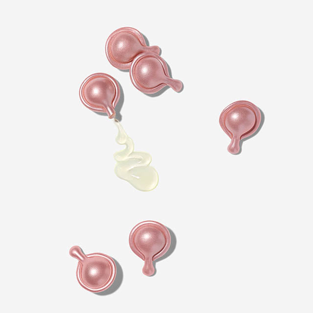 Retinol HPR Ceramide Capsules scattered with texture coming out of one of the capsules